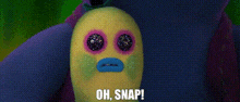 a close up of a troll doll with a face and the words `` oh snap '' .