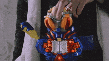 a person is holding a toy that has the letter x on the back