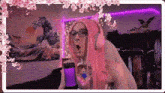 a person with pink hair and headphones is standing in front of a microphone in a room .