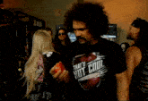 a man with a mustache wears a shirt that says that 's not cool