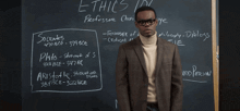 a man standing in front of a blackboard with the word spreadsheet written on it