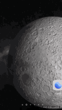 a phone screen shows a picture of the moon and an app called earth