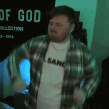 a man is dancing in front of a sign that says god collection