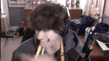 a person wearing headphones is sitting in front of a microphone .