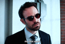 a man wearing sunglasses and a suit says say that again