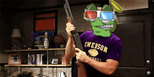 a man wearing a purple emerson shirt is holding a gun