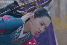 a woman with a bow and arrow in her hair says " darn it "