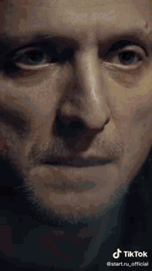 a close up of a man 's face with a tiktok logo