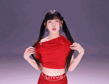 a woman in a red crop top and skirt with the word studio on the bottom