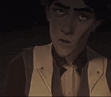 a close up of a man 's face with a vest on