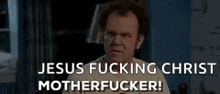 a man is standing in a room with the words `` jesus fucking christ motherfucker '' written on the bottom of his face .