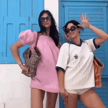 two women standing next to each other one wearing a white shirt with the letter o on the front
