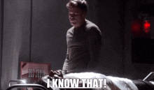 a man standing next to a woman in a hospital bed with the words i know that written on it