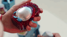 a close up of a person holding a toy that says ' ii ' on the front
