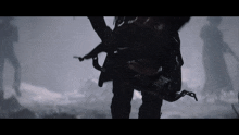 a person holding a gun in a foggy scene