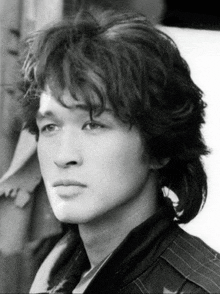 a black and white photo of a young man