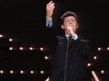a man in a suit and tie has his arms outstretched