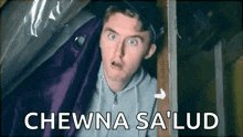 a man is standing in a room with a purple curtain and the words chewna sa lud written on the bottom