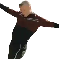 a man in a red and black shirt and black pants is standing with his arms outstretched