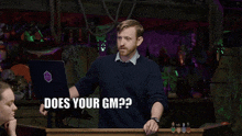 a man stands at a podium and says " does your gm " in front of a laptop
