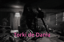a black and white photo of a man holding a gun with the words torki de dania written in pink