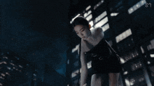 a woman in a black dress is reaching out to another person