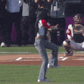 a woman stands on a baseball field holding a baseball mitt