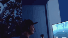 a man wearing headphones looks at a computer monitor