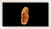 two fried chicken nuggets are sitting on a black surface .