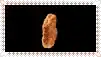 two fried chicken nuggets are sitting on a black surface .