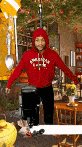 a man wearing a red american eagle hoodie