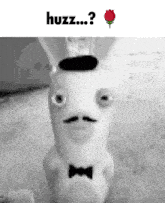 a picture of a rabbit with a bow tie and a hat that says huzz on it