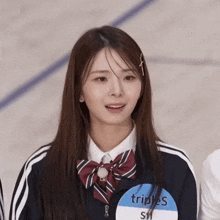 a woman wearing a name tag that says triples on it