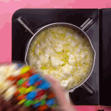 a person is pouring m & ms into a pot of food