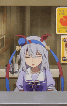 a girl in a purple dress is sitting at a counter in front of a sign that says ' a ' on it