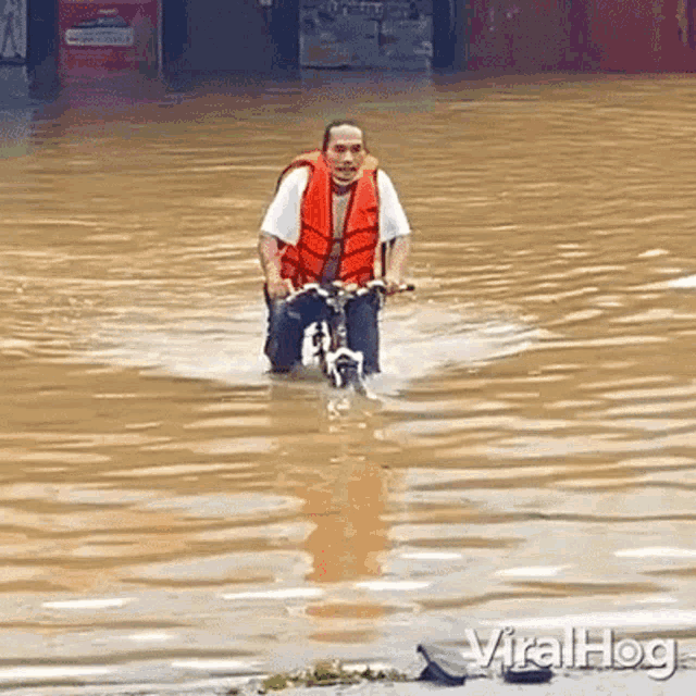 Riding A Bike Viralhog GIF - Riding A Bike Viralhog Riding A Bike In The Flood GIFs