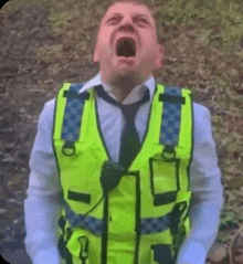 a man wearing a yellow vest and tie is shouting .