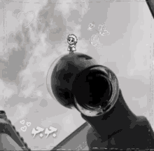 a black and white photo of a person holding a glass with hearts and butterflies around it