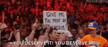 a crowd of people are holding up signs that say give me the milk of indonesia
