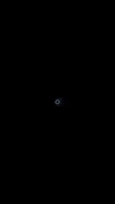 a dark background with a white circle in the middle of it