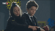 a boy and a girl are dancing in a room with trt1 written on the bottom