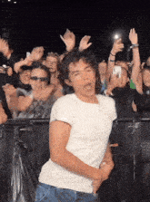 a man is dancing in front of a crowd at a concert