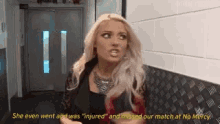 a woman is standing in a hallway with the words `` she even went and was injured '' .