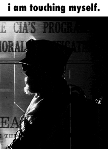 a black and white photo of a man with the words " i am touching myself " below him