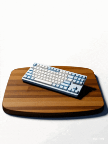 a keyboard sits on a wooden cutting board that says runway on it