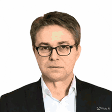 a man wearing glasses and a suit has the word video on the bottom