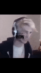 a man wearing headphones with the word wow written on his face