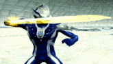 a cartoon character in a blue and silver suit is holding a yellow object