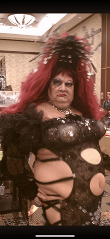 a drag queen with a very large red wig