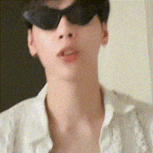 a close up of a person wearing sunglasses and a shirt